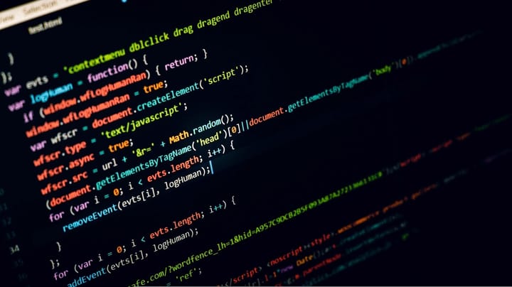 Colourful source code on a dark screen