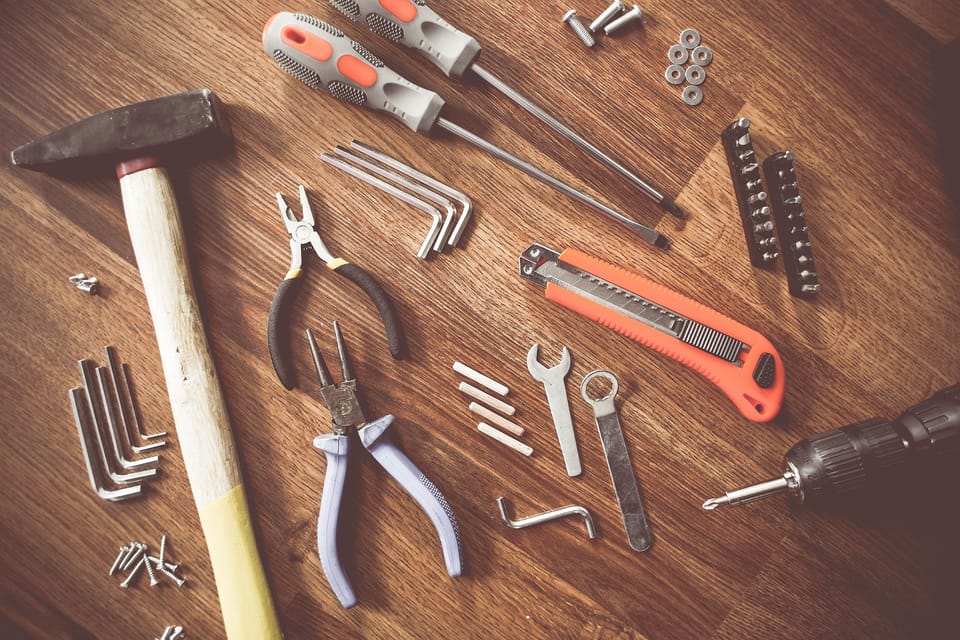 Hand tools spread out on a wooden table