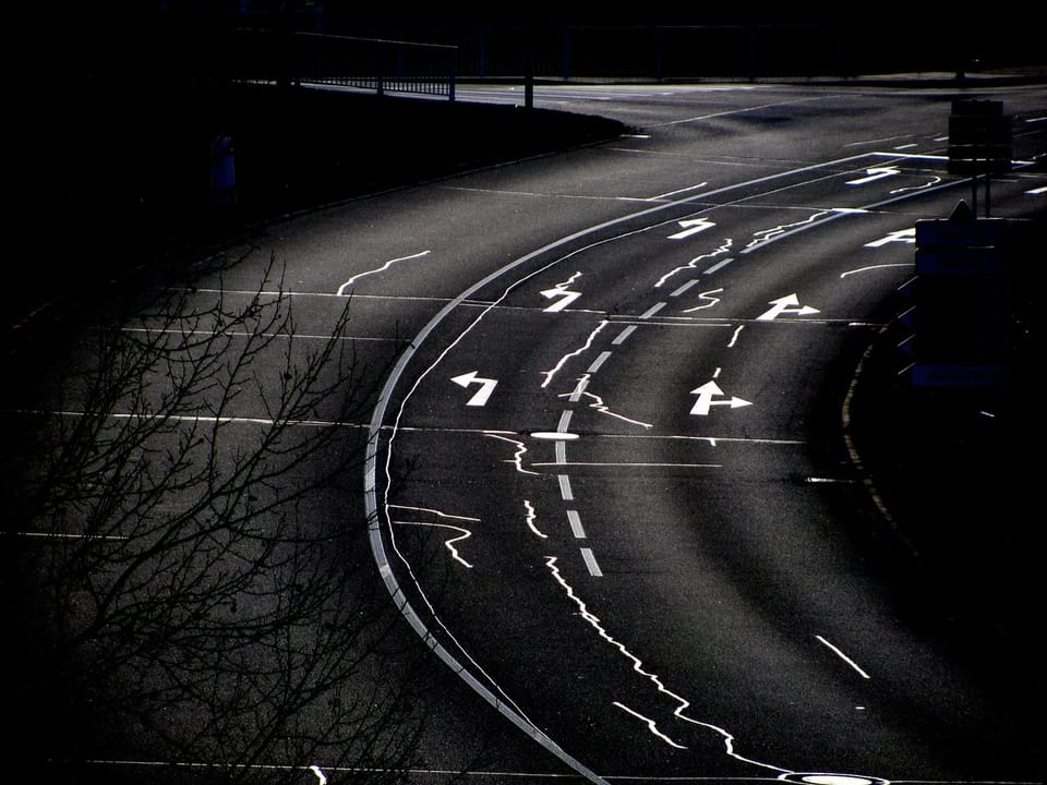 Light trails of cars on a winding road at night
