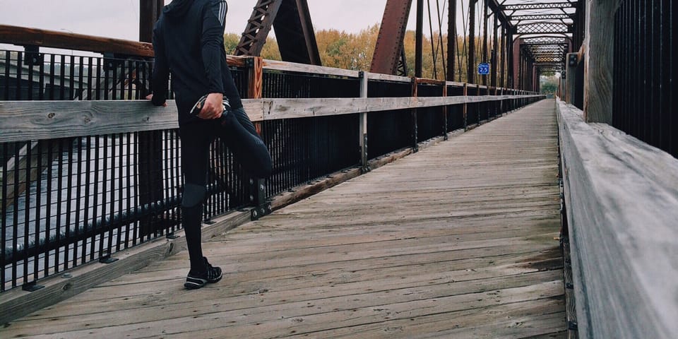 Person running on a wooden bridge